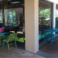 Outdoor seating next to small garden. at Living Vine Organic Cafe in Fort Myers