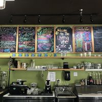 The menu is so cute! Right over the smoothie & coffee station where you order at. Shows the smoothie, protein shake, coffee, and tea selection. at Living Vine Organic Cafe in Fort Myers