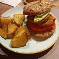 The burger was fine, but the roasted potatoes were amazing! at Pappare' in Bologna