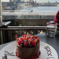 The extremely tasty Vegan birthday mud cake with fresh berries, edible flowers & gold leaf  at Cafe Sydney in Sydney