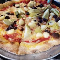 Pizza with both vegan cheeses, artichoke, kalamata olives and roasted garlic at Ghiringhelli's Pizzeria in Fairfax