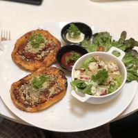 Pizza with vegan sausage and parmesan and side of ceaser salad at Veganerie - Ratchathewi in Bangkok