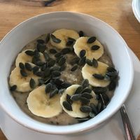 Chia seed porridge with banana and pumpkin seeds at Ahimsa The Vegan Cafe in North West London