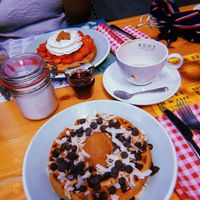 Top one: regular waffle with peanutbutter, strawberrie and whipped cream. Lower one: Vegan waffle with peanutbutter, dark chocolate chips, roasted coconut flakes and maple syrup. at Brunchroom in Amsterdam