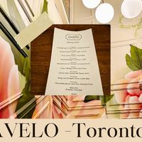 Menu and restaurant wall  at Avelo in Toronto