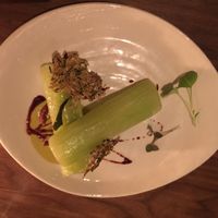 Lettuce stem with zucchini cracker and some kind of sauce at Avelo in Toronto
