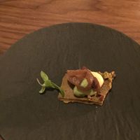 Pistachio cracker with edamame purée and something else at Avelo in Toronto