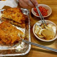 two pancakes with kimchi and soy sauce onions on the side at Soonheene Bindaeddeok - 순희네 빈대떡 in Seoul