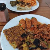 Well cooked eggplant and potato dish, mücver (Turkish zucchini fritter), börek, manti... at Vegan Istanbul in Istanbul
