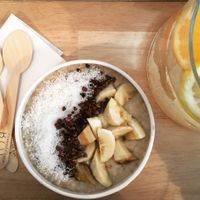 Porridge topped with banana coconut and cacao nibs at BOL Porridge Bar in Paris
