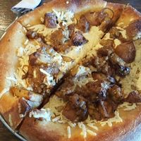 Small pizza with garlic olive oil base, daiya cheese, caramelized onions, roasted potatoes, and tempeh. Was amazing! at Mellow Mushroom in Houston