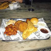 Vegan BBQ Monday Vegan Sampler Tray: chick'n tenders, pickles, sausage, brisket, fried green tomatoes, bread roll, slaw, BBQ sauce and aioli at The b.east in Brunswick East