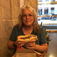 Mom eating the best Philly cheesesteak ever at HipCityVeg - Broad St in Philadelphia