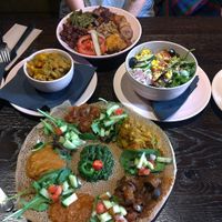 Mains: Wild rice bowl, Injera (with extra Injera); sides: Cole slaw, masala veggies, side salad at Mooshka in Amsterdam