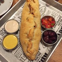 Shwarma in a fresh baked crust with sauces and olives at Four One Six (416) in Tel Aviv