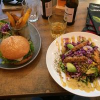 Salad with tempeh and avocado on the right, burger with chickpea patty on the left  at Balans Bistro in Bratislava