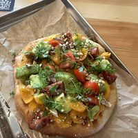 Baked pita with sweet potato hummus, avocado and cherry tomatoes  at Balans Bistro in Bratislava