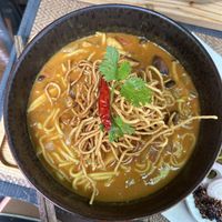 khao soi - northern thai noodle soup with a coconut broth and crispy noodles on top  at Reform Kafe in Chiang Mai
