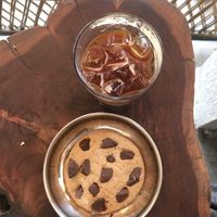 Homemade vegan choc chip cookie and iced americano! They also have soy/coconut milk options!  at Depth N Green in Mysore