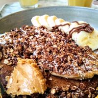 The Co'Yo Crazy vegan pancakes with coconut yoghurt, peanut butter, banana, maple syrup and chocolate sauce at O'YO - Brabantdam in Ghent