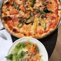 Vegetarian pizza with a side of salad (we asked for a vegan salad instead and got this one replaced) at KaffeeKlatsch in Davos Platz