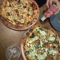 cheeseburger pizza (LHS) and chicken souvelaki pizza (RHS)  at Red Sparrow Pizza & Rooftop Bar in Fitzroy