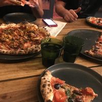 On the left: (special) burger meat, bacon, onion rings, pickles and BBQ 
On the right and middle bottom the puttanesca  at Red Sparrow Pizza in Collingwood