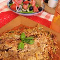 Lasagna with greek salad in the back at By Valeria in Santa Maria