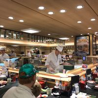Sushi chefs behind the conveyor belt at Katsu Midori in Tokyo