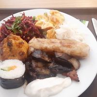 Sushi, breaded cauliflower, cabbage salad, spring roll, eggplant, sweet potato salad at Veganland - Karlovo Namesti in Prague