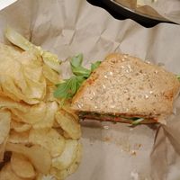 My half-devoured Hummazing Vegan sandwich.... and it really was Humming!! ? With a side of vegan in-house potato chips at Even Stevens Sandwiches in Logan