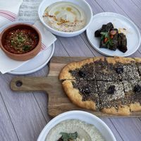 From left to right: Muhammara, hummus, dolmas, maneesh, and babaganoush  at Zeytoon Cafe in Laguna Beach