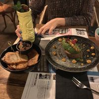 Open avocado and a sort of patatas bravas  at Gorilla in Turin