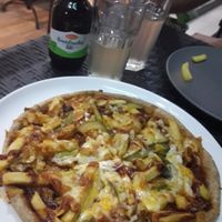 American burger pizza with fries at Vege Joy in Varna