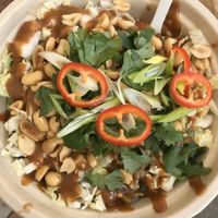 Black bean noodles on bottom (cold) with greens, peppers, nuts, delicious sauce  at Delicious Raw Kitchen and Juice Bar - maybe close in Estero