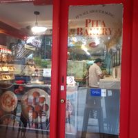 Little sweet place with two tables outside at Pita Bakery in Central Singapore