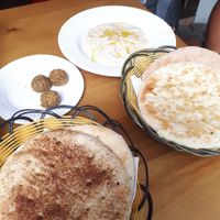 Garlic pide, cinammon pide whole meal pide with hummjs and baba ganush at Pita Bakery in Central Singapore