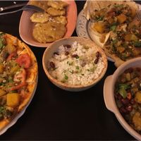 Vegan pizza, tostones, rice, veggie tacos, and black bean stew at El Shamuskia'o in Havana