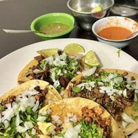 Tacos served with lime slices and two salsas  at VEGuerrero in Mexico City