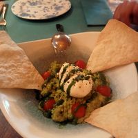 Burrata de almendras sobre aguacate con tomate y pesto at BumpGreen in Madrid