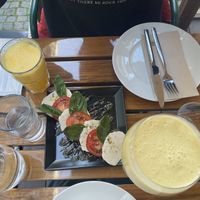 Caprese salad, fresh orange juice and mango lassi  at Organi Chiado in Lisbon