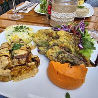 Marinated tofu, deep fried cale, sweet potato purée, rice and salad at Organi Chiado in Lisbon