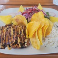 Seitan Steak with homemade chips, rocket salad with pomegranate seeds and rice at Organi Chiado in Lisbon