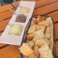 Three dips & bread. Olive and basil were the best of the three. at Organi Chiado in Lisbon