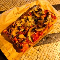 Funghi pizza slice at Romana Pizza in Lisbon