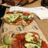 Vegan pizza in the front at Romana Pizza in Lisbon