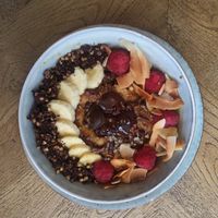 Espresso-chocolate porridge with homemade brownies, banana, dark chocolate, roasted coconut and raspberries. at Brochan in Edinburgh