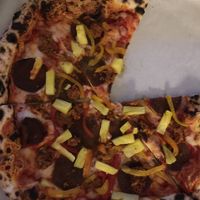 Supreme pizza with pineapple, peppers, vegan pepperoni and sausage  at Floralia in Honolulu