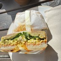 Scrambled tofu + sriracha Bagel  at The Fields Beneath - Kentish Town in North West London