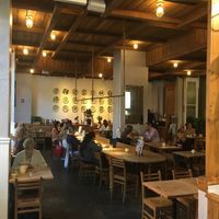 Seating inside; note communal tables and separate tables at Le Pain Quotidien - 65th & Lexington in New York City